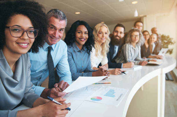 The business goal of Logos IT Solutions Inc. Business people stay along the table.